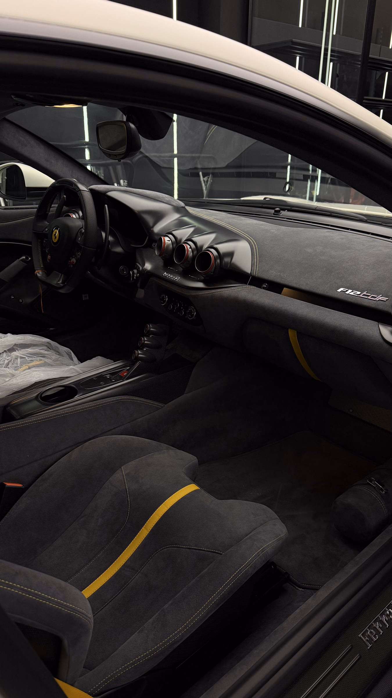 Ferrari 812 cabin trimmed in Alcantara with yellow stitching after a full interior detail